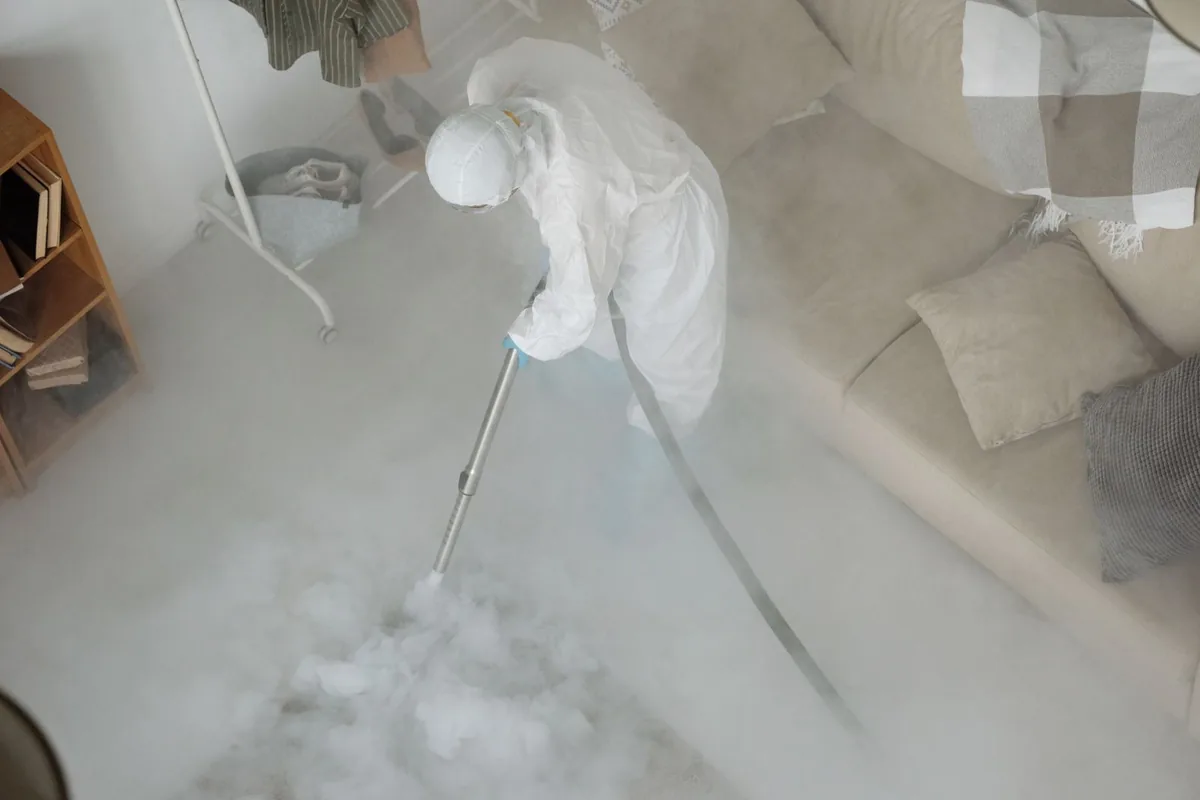 Biohazard cleanup technician in protective equipment, Chelsea, MA